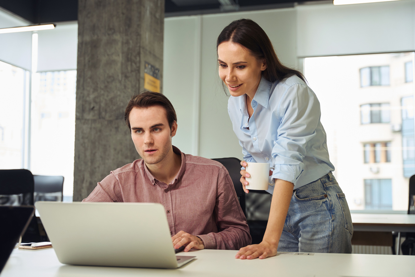 New office employee performing job task supervised by company manager